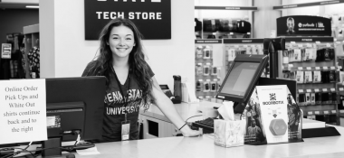 Cashier girl standing and smiling at a retail store