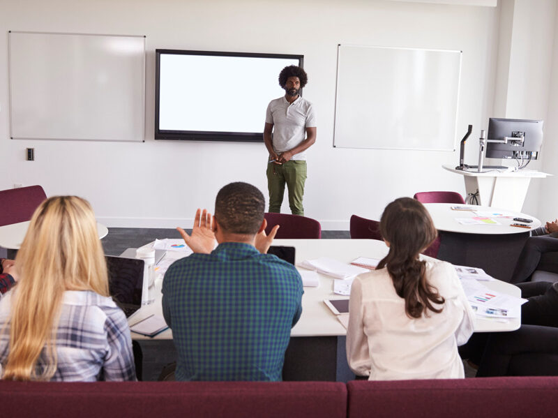 A student speaking before so many students sitting in a classroom