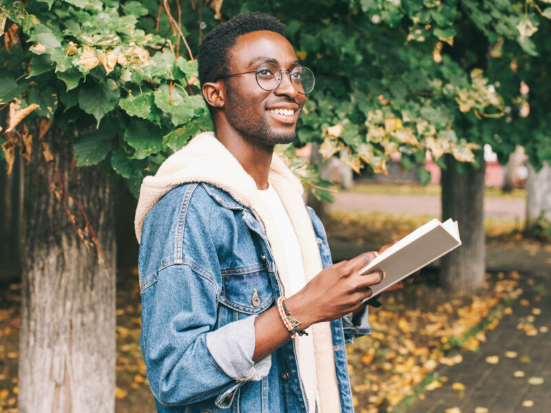 student holding book